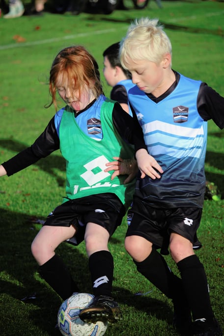 Kids and coach on the grass at Huapai Domain